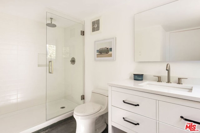 bathroom featuring an enclosed shower, vanity, and toilet