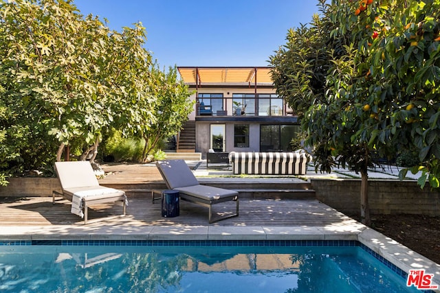 view of swimming pool with a deck