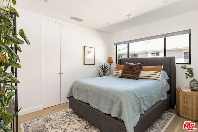 bedroom featuring a closet and light hardwood / wood-style flooring