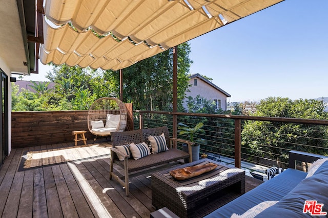 deck featuring an outdoor living space and a pergola