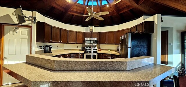 kitchen with wood ceiling, high vaulted ceiling, kitchen peninsula, ceiling fan, and stainless steel appliances