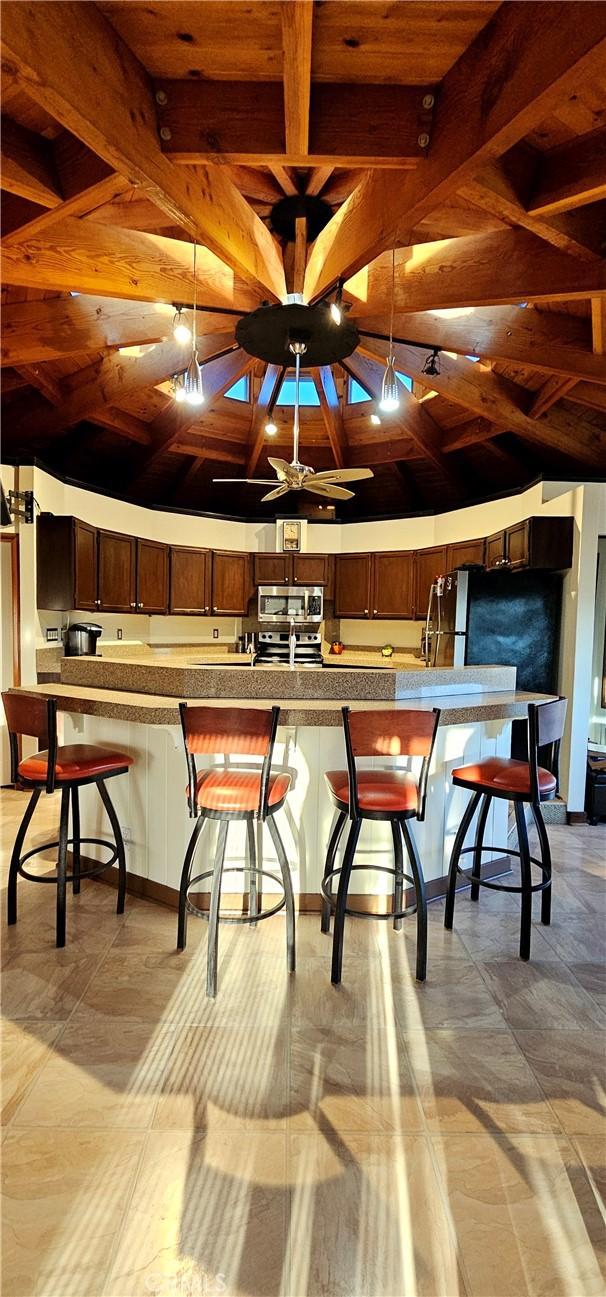 dining space with wood ceiling and beamed ceiling