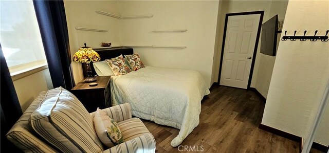 bedroom featuring dark hardwood / wood-style flooring