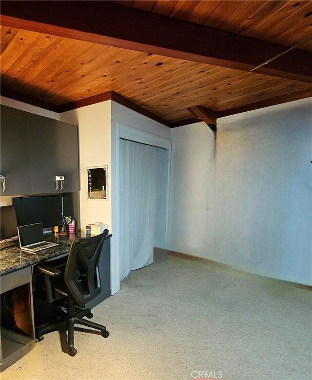 office featuring light carpet, wood ceiling, built in desk, and beamed ceiling