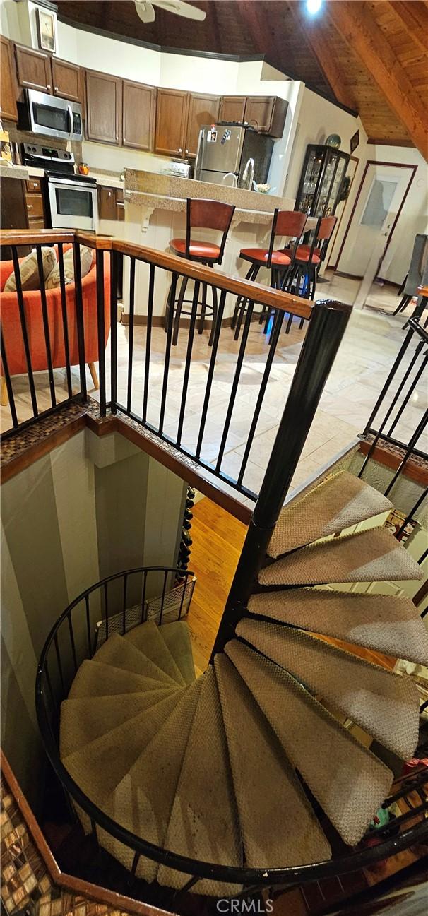 staircase featuring hardwood / wood-style floors and beam ceiling