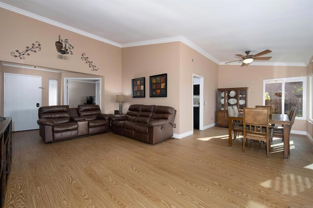 living room featuring ceiling fan, ornamental molding, and light hardwood / wood-style flooring