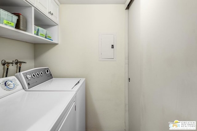 clothes washing area featuring cabinets, electric panel, and washer and dryer