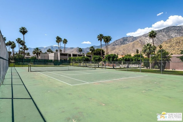 view of tennis court featuring a mountain view