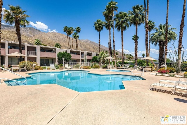 view of pool featuring a patio area and a mountain view