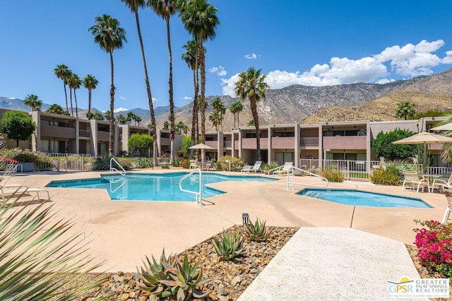 view of pool featuring a patio area and a mountain view