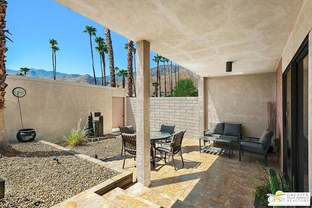 view of patio / terrace featuring a mountain view and an outdoor hangout area