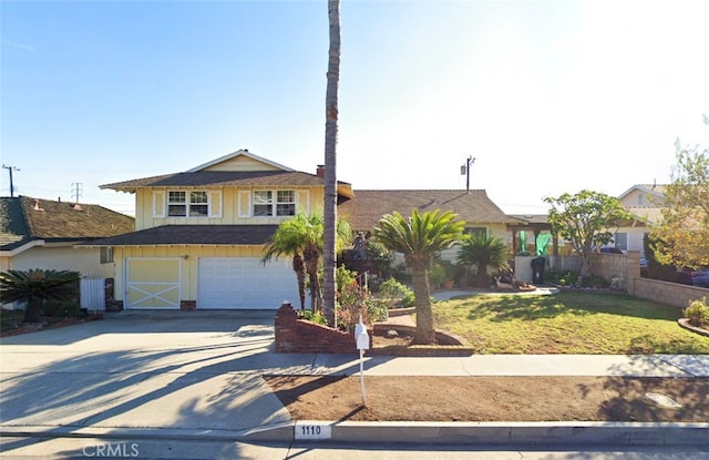 view of front of property with a garage and a front lawn