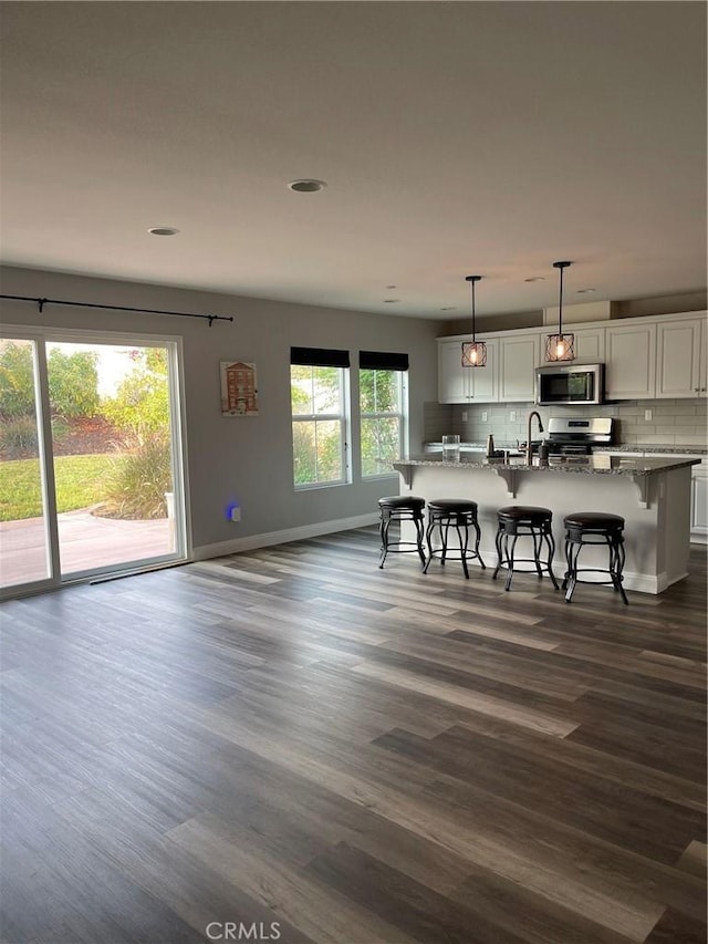 dining space featuring plenty of natural light, dark hardwood / wood-style floors, and sink