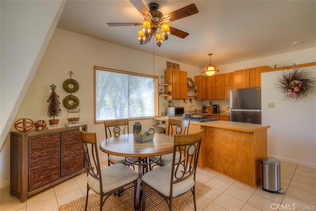 dining area featuring ceiling fan and light tile patterned flooring