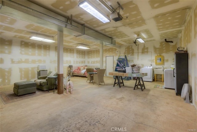 basement featuring independent washer and dryer and sink