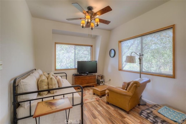 living room featuring ceiling fan and light hardwood / wood-style floors