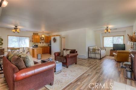 living room featuring ceiling fan and light wood-type flooring