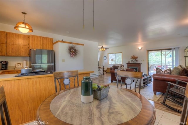 tiled dining room with ceiling fan