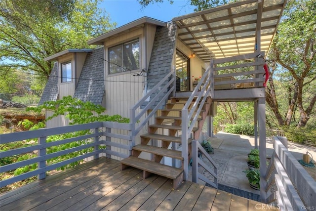 exterior space with a wooden deck and a pergola