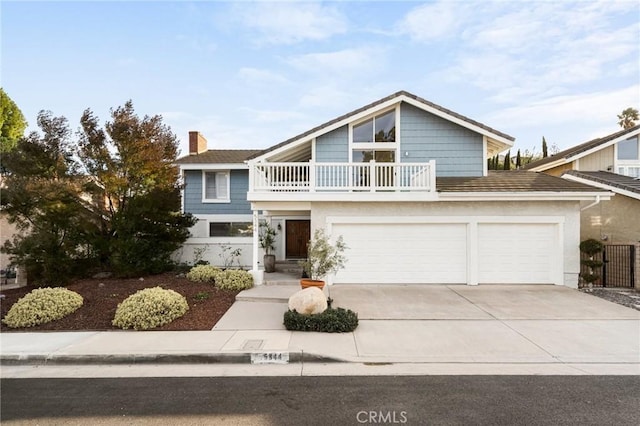 view of front of home with a balcony and a garage