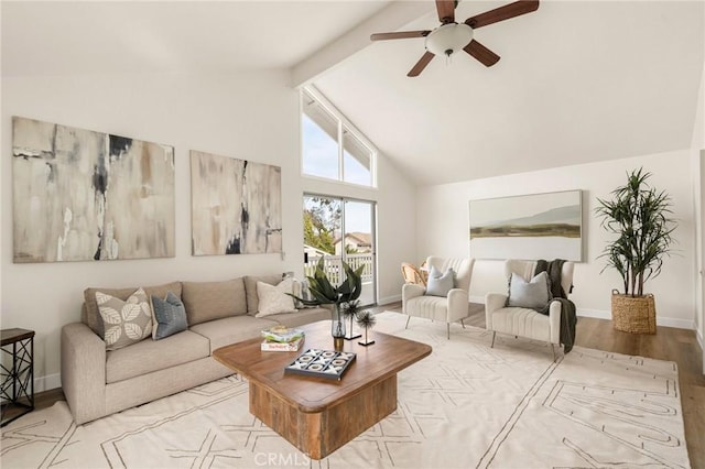 living room featuring vaulted ceiling with beams, light hardwood / wood-style floors, and ceiling fan