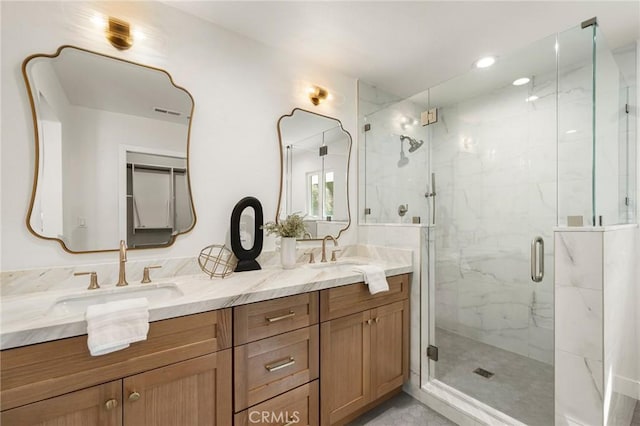 bathroom featuring vanity and a shower with shower door