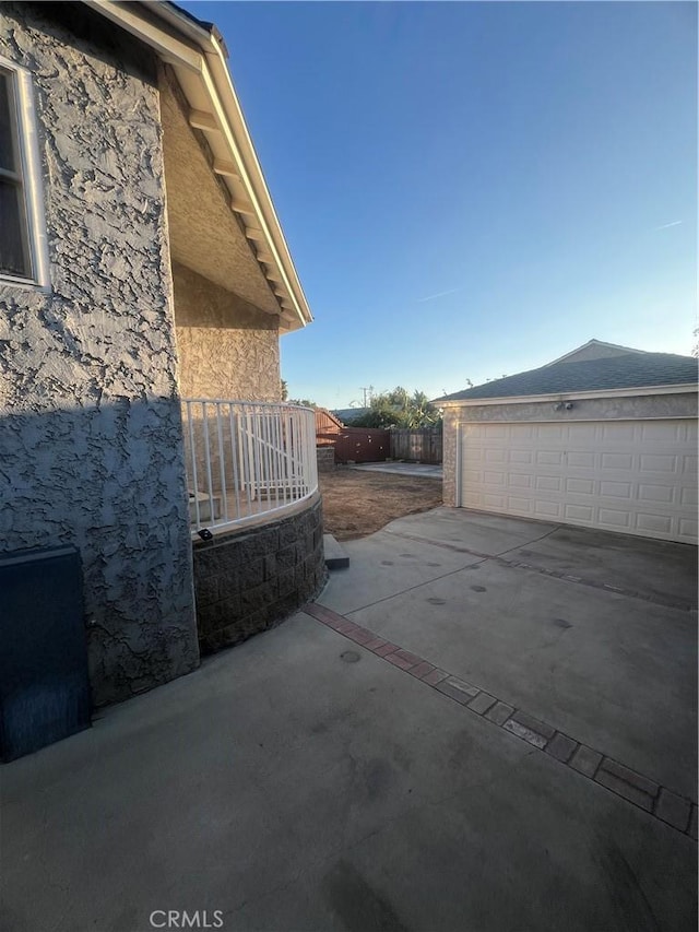 view of patio with an outdoor structure and a garage