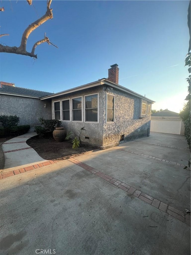 view of property exterior with a patio area