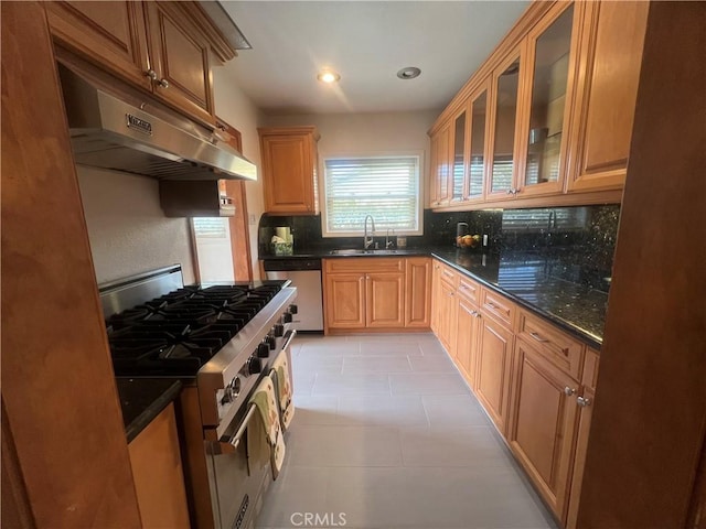 kitchen featuring light tile patterned floors, a sink, stainless steel appliances, under cabinet range hood, and backsplash