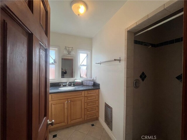 bathroom featuring a shower, tile patterned floors, and vanity