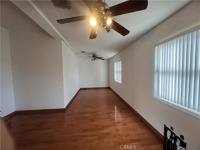 empty room featuring ceiling fan and dark hardwood / wood-style floors