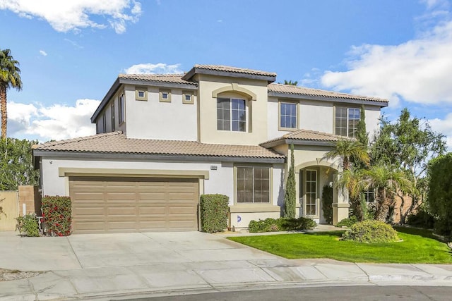 mediterranean / spanish-style house featuring a front lawn and a garage