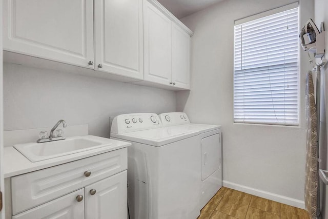 washroom featuring cabinets, sink, and independent washer and dryer