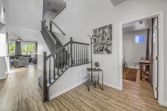 staircase with ceiling fan