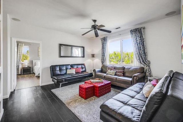 living room with ceiling fan and dark hardwood / wood-style flooring