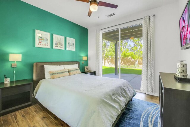 bedroom featuring ceiling fan, access to exterior, and dark hardwood / wood-style floors