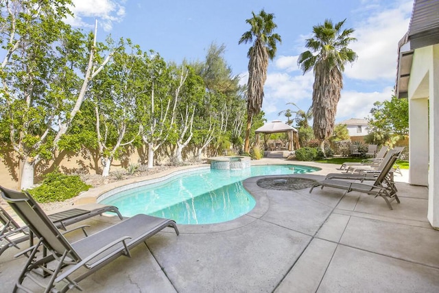 view of pool featuring an in ground hot tub, a patio area, and a gazebo