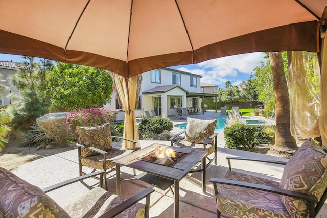 view of patio with a fire pit and a fenced in pool