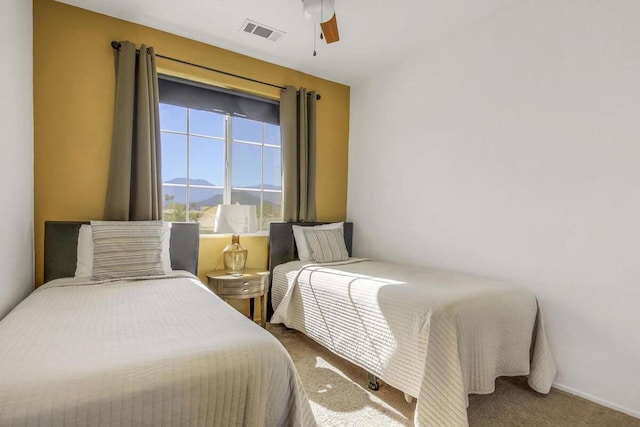 bedroom with ceiling fan, a mountain view, and carpet floors