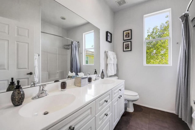 bathroom with toilet, tile patterned floors, and vanity