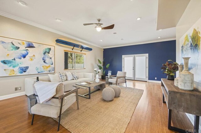 living room with hardwood / wood-style flooring, french doors, crown molding, and ceiling fan