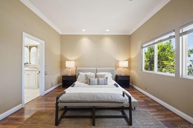 bedroom with dark wood-type flooring, ensuite bathroom, and crown molding