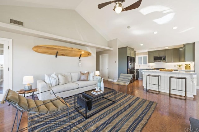 living room with dark wood-type flooring, high vaulted ceiling, and ceiling fan