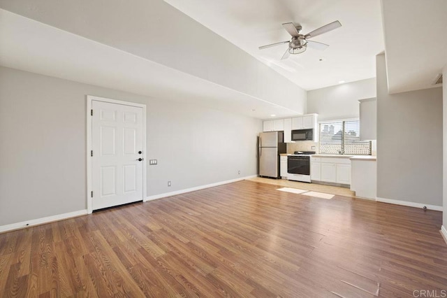 unfurnished living room with ceiling fan and light hardwood / wood-style floors