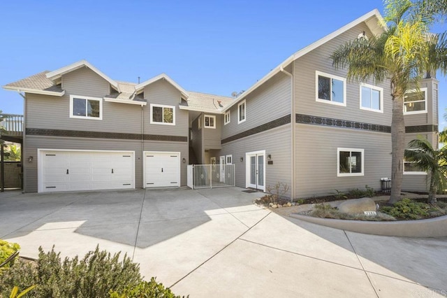 view of front facade with a garage and french doors