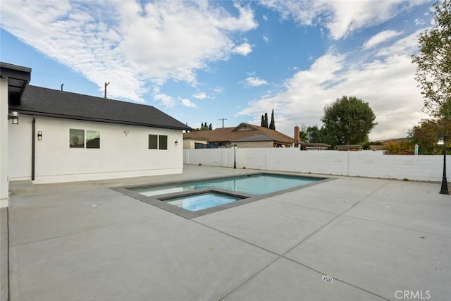 view of pool featuring an in ground hot tub and a patio