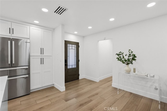 foyer entrance with light hardwood / wood-style flooring