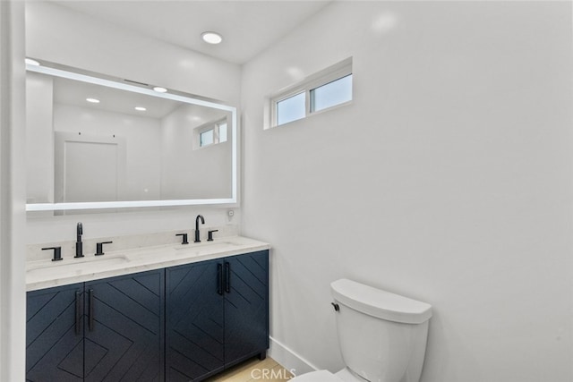 bathroom featuring toilet and vanity