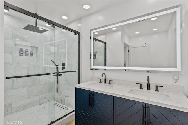 bathroom with vanity and a shower with door