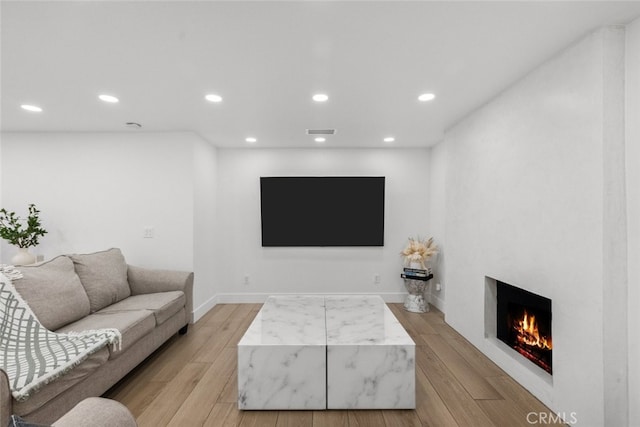 living room with light hardwood / wood-style flooring